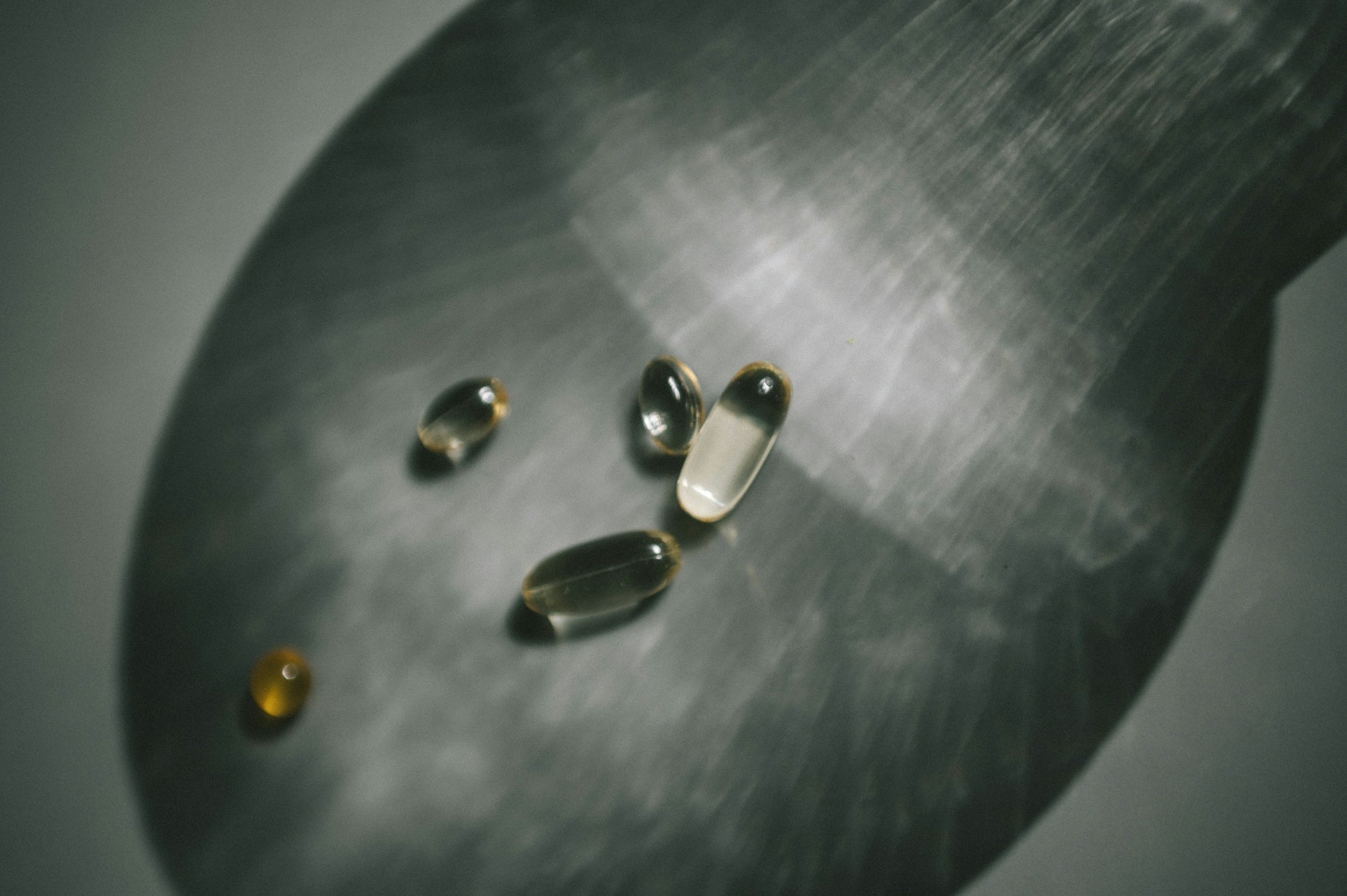 close-up of several softgel capsules with light refraction