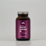front view of amber glass with organic evening primrose oil capsules on light background 